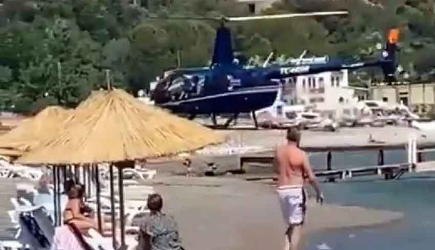 Marmaris'te iki iş insanı yemek için halk plajına helikopterle iniş yaptı